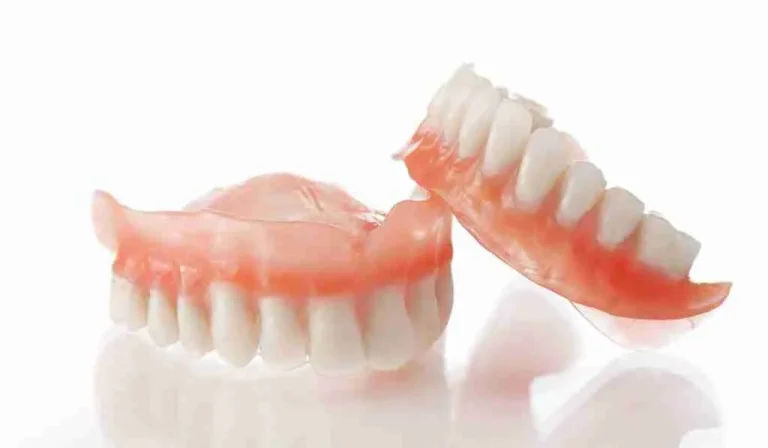 Complete upper and lower acrylic dentures with pink gum-colored bases